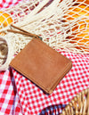Small Camel Hunter Leather coin purse. Square shape. Lifestyle image
