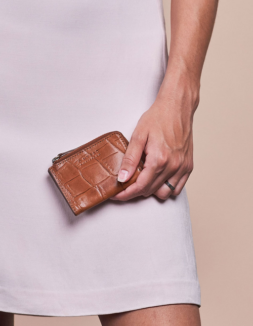 Small Cognac Croco coin purse. Square shape. Model image