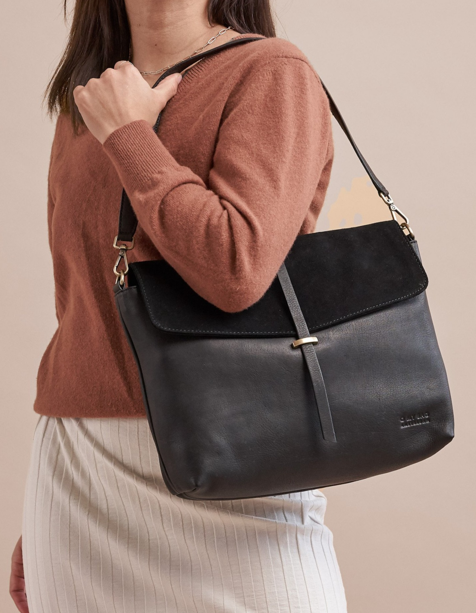 Black Soft Grain & Suede leather womens handbag. Square shape with short adjustable strap. Model product image.