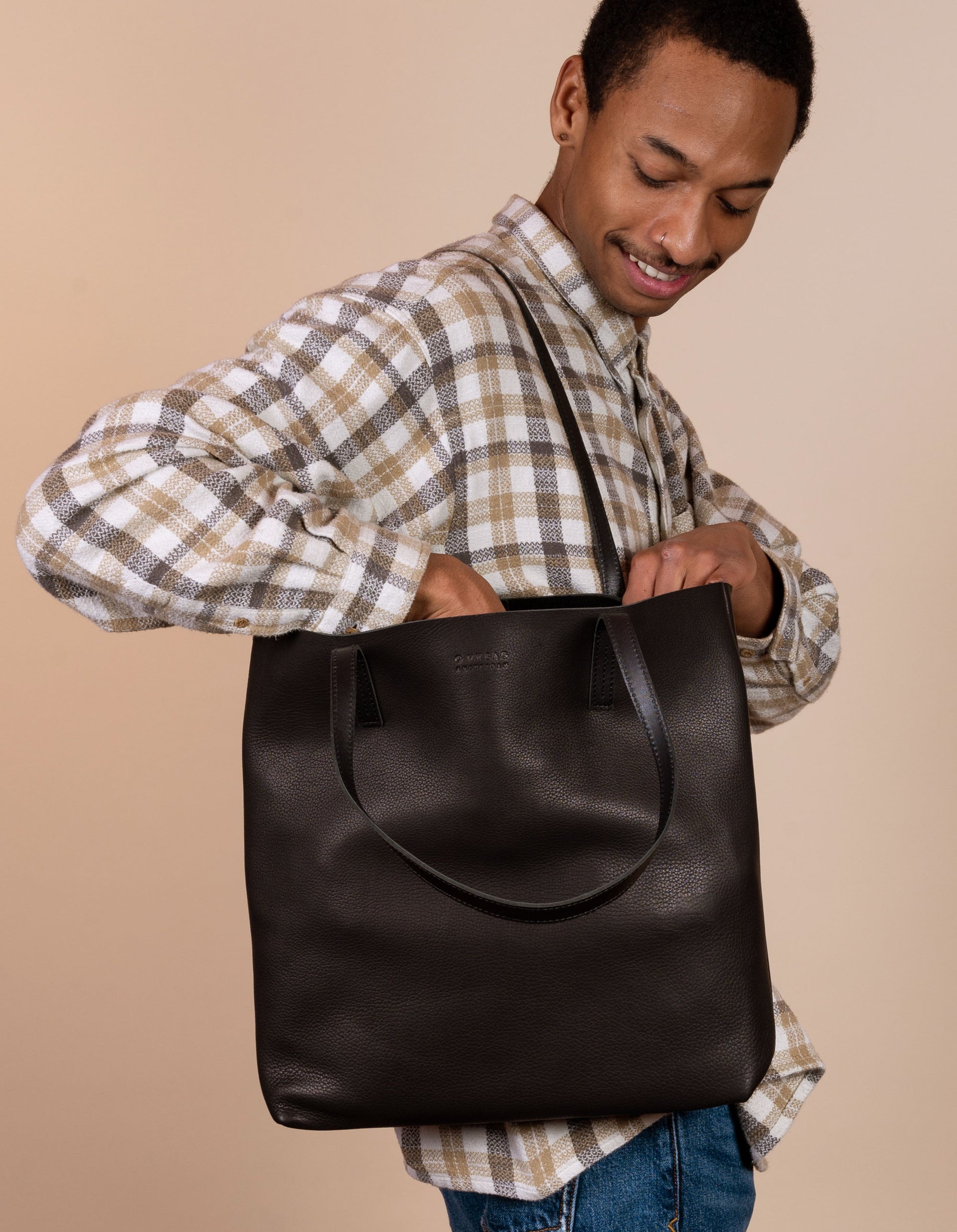 Georgia tote in black soft grain leather - male model product image - side angle