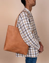 Camel Leather womens shopper bag. Square shape. Male model product image.