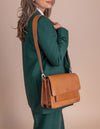 Harper Cognac Leather crossbody handbag. Product model image with wide strap.