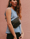Black Croco Leather womens fanny pack. Square shape with an adjustable strap. Lifestyle product image