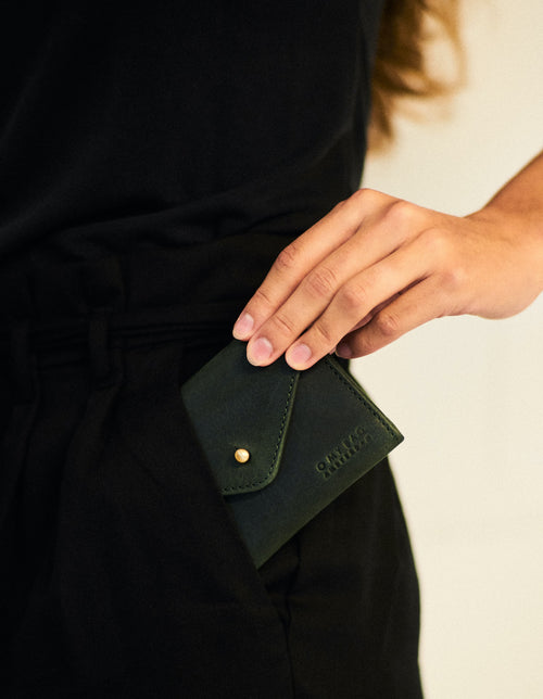 Green Leather wallet. Envelope shape. Lifestyle product image.