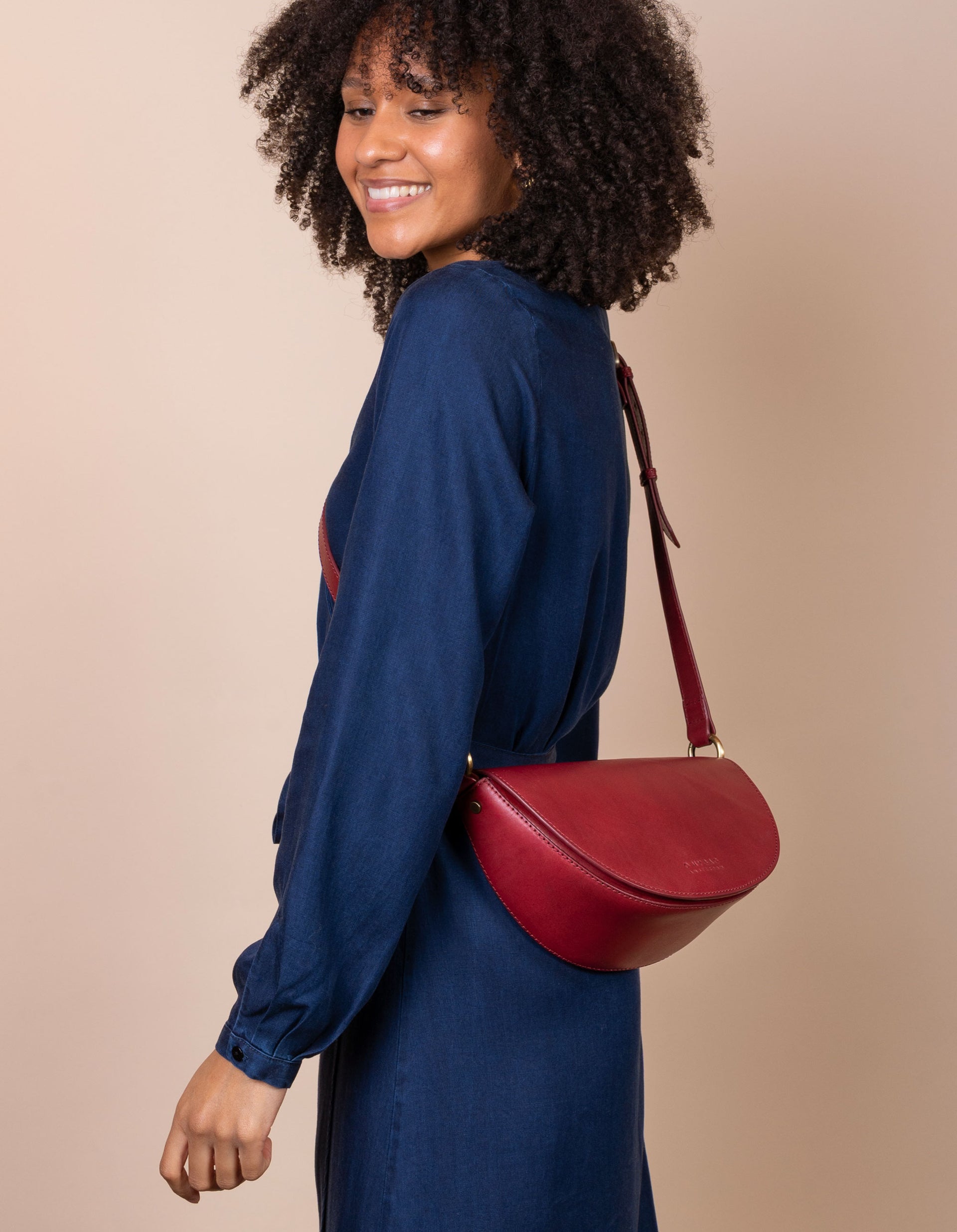 Laura Bag in Ruby Classic Leather ft. Adjustable leather strap - Female model product image