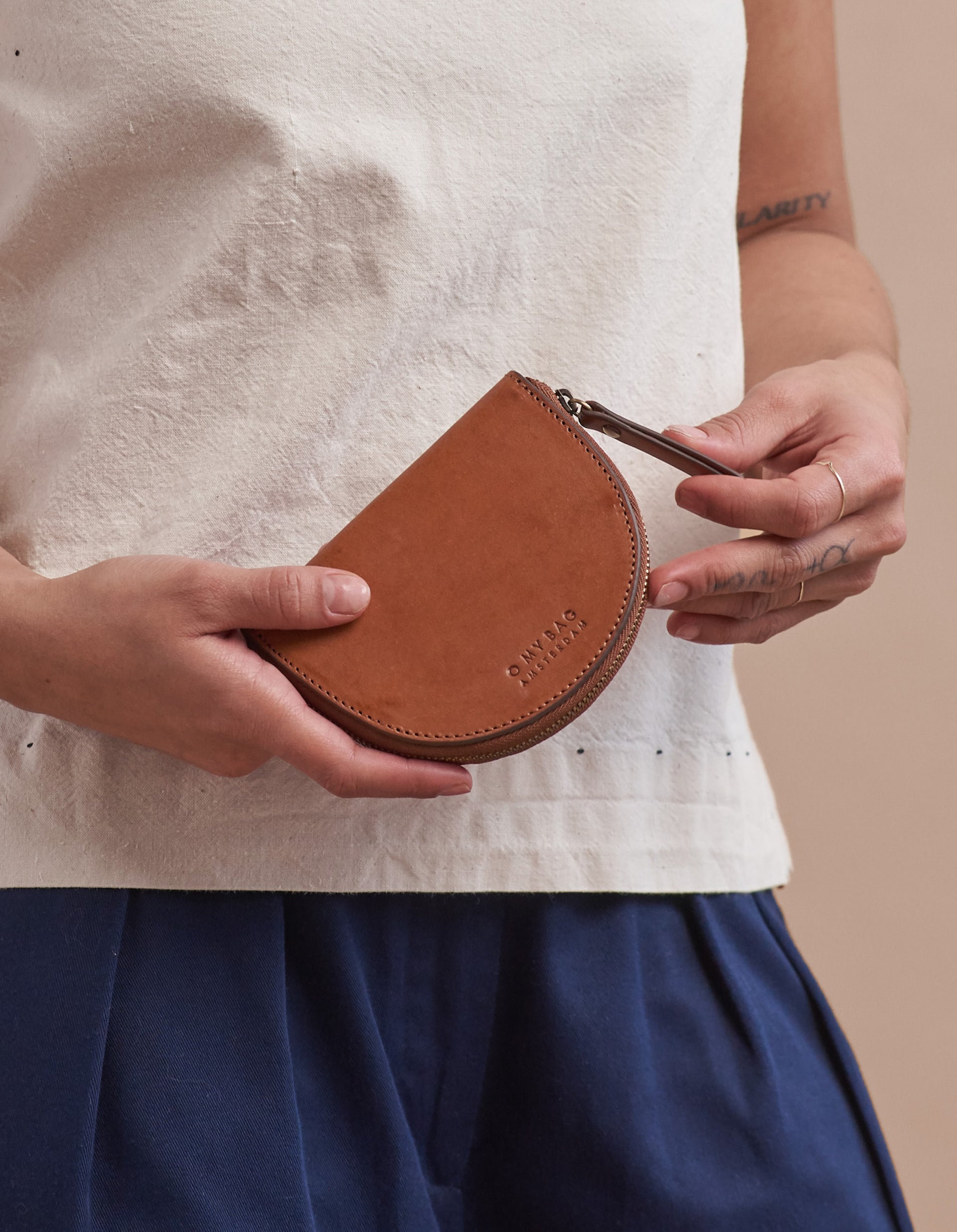 Small Cognac leather coin purse. Model imageSmall Cognac leather coin purse. Model product image