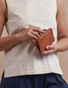 Lola Coin Purse Cognac Leather. Small purse. Model image