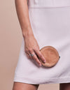 Luna Purse Camel Hunter Leather. Circular coin purse, wallet for men and women. Model image.