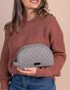 Striped half moon makeup bag lifestyle image. Moon Makeup Bag - Cotton Black Classic Leather. Model images
