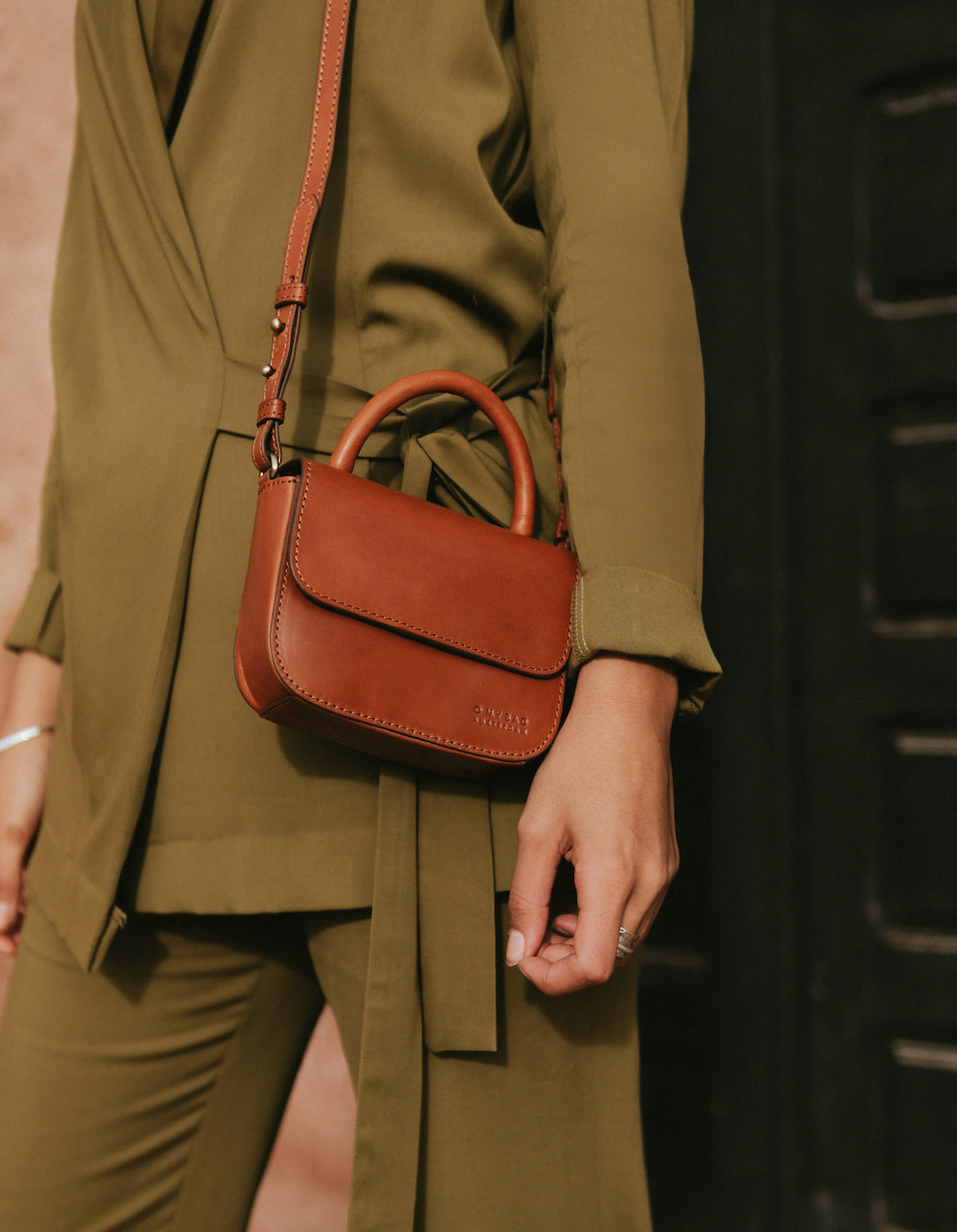 Nano Bag Cognac Classic Leather. Small clutch handbag, party bag. Model image.