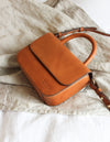 Nano Bag Cognac Classic Leather. Small clutch handbag, party bag. lifestyle image.