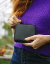 Sonny Square Zip Around Wallet Black Vegan Apple Leather. Lifestyle Model image