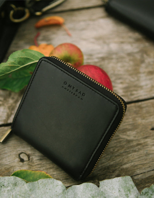 Sonny Square Zip Around Wallet Black Vegan Apple Leather. Lifestyle image